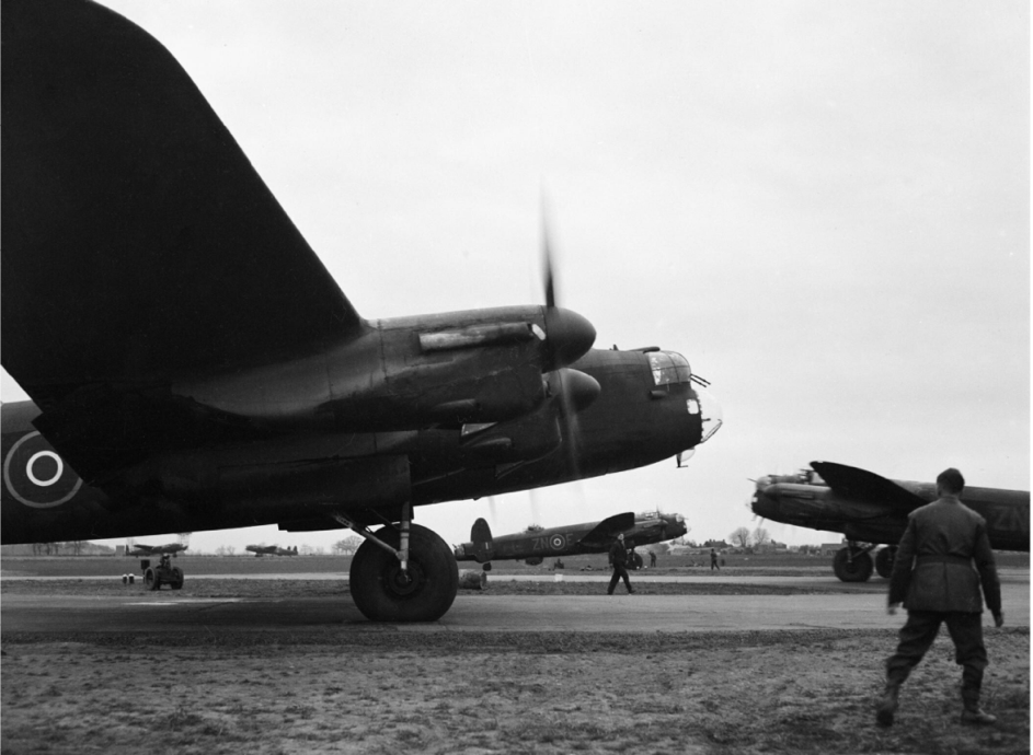 (1) Heavily-laden Avro Lancaster B           Mark IIIs of No. 106 Squadron RAF taxy from their dispersals